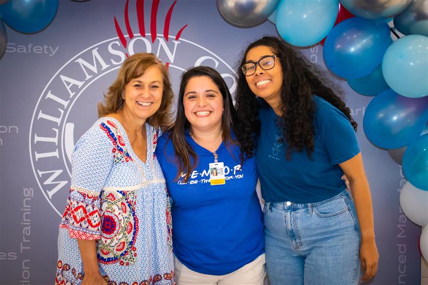A group of teachers smile